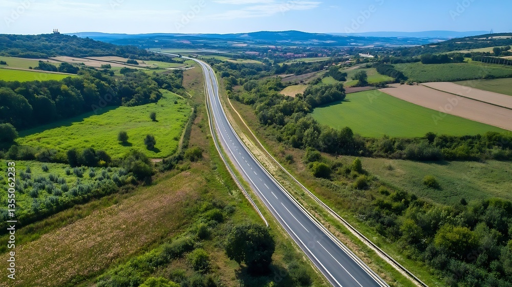 Poster aerial view of a curving road through vibrant green fields and rolling hills in the countryside : ge