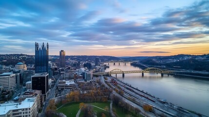 Fototapeta premium Breathtaking aerial view of Pittsburgh city skyline at sunset showing rivers and bridges reflecting golden light : Generative AI