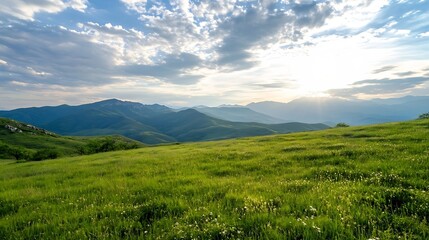 Obraz premium Breathtaking panoramic view of a sunlit green valley surrounded by majestic mountains under a blue sky : Generative AI
