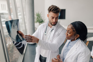 Obraz premium Doctors examining x ray of patient in hospital or clinic