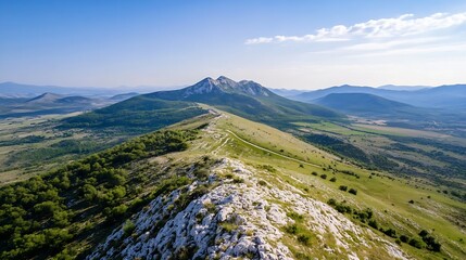 Fototapeta premium Breathtaking Aerial View of Mountain Peaks and Rolling Hills Under a Clear Blue Sky : Generative AI