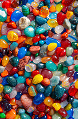 A vibrant collection of polished stones each holding a unique story radiating light and texture sharp focus