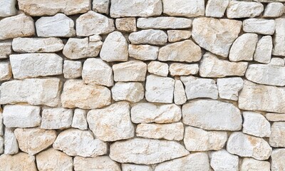 Fototapeta premium Natural stone wall texture with rugged details, perfect for backdrops, wallpapers, and architectural designs. Ideal for adding a rustic and earthy feel to creative projects.