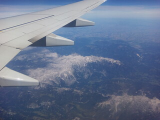 Fototapeta premium Breathtaking aerial view of mountain ranges captured during a clear daytime flight