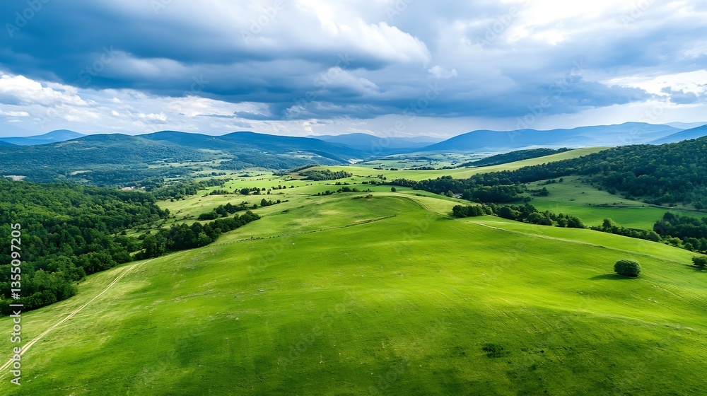 Poster panoramic view of expansive green hills and clouds above mountainous terrain under a bright sky : ge