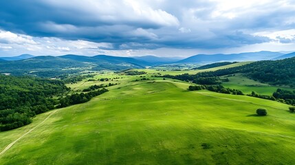 Obraz premium Panoramic view of expansive green hills and clouds above mountainous terrain under a bright sky : Generative AI