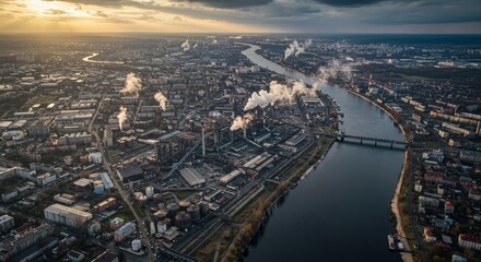 Fototapeta premium Industrial River City: A View of Urban Development and Environmental Concerns - Aerial view of an industrial zone alongside a river, depicting smoke emissions from factories, symbolizing pollution