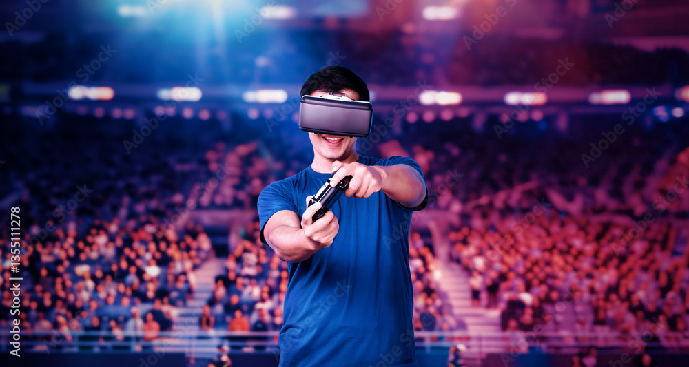 Poster adult holding joystick and wearing vr goggles while enjoy playing games at stadium with blurring bac