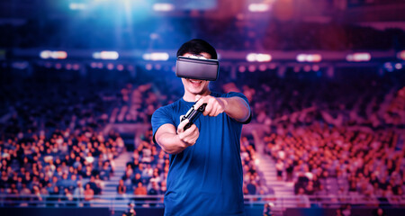 Adult holding joystick and wearing VR goggles while enjoy playing games at stadium with blurring...