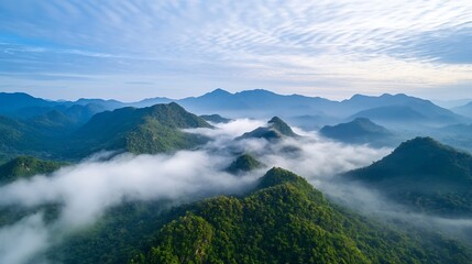 Fototapeta premium Majestic aerial view of lush green mountains surrounded by fog and mist under a serene sky : Generative AI