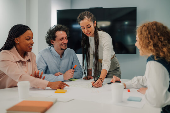 Diverse business team collaborating on project in modern office