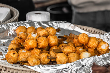 Skewers with thai fried fish balls at food street market