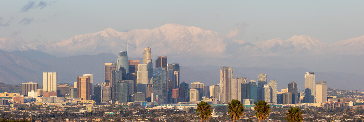 Los Angeles skyline with snow covered mountains in the distance