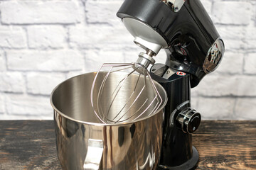 Planetary mixer, whisk and bowl close-up, kitchen equipment.
