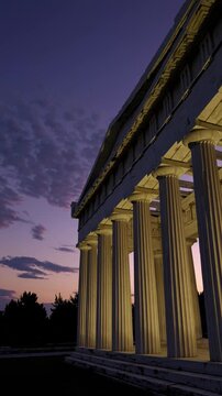 A dramatic low-angle video shot of an ancient Greek temple at dusk, highlighting its illuminated columns against a purple and pink sky. Live mobile wallpaper.