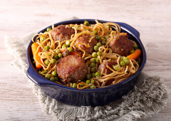 Meatballs with pasta, peas and carrot