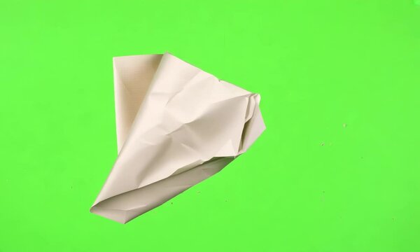 Stop motion animation of crumpled pape on a green screen background