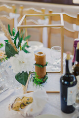 Wedding table decor. Candle on the table with live decoration