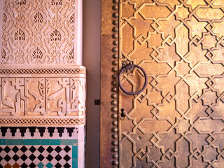 Ben Youssef Madrasa entrance door bronze work aside stucco work and sellij mosaic, Marrakesh