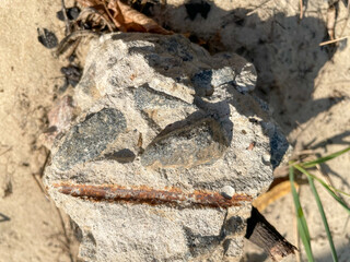 Broken stone on the sand in summer. natural stone