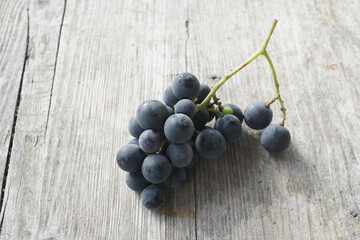 Dark Grapes on a Rustic Wooden Table