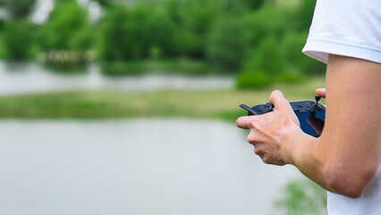 Close-up of a drone operator with a remote control in his hands