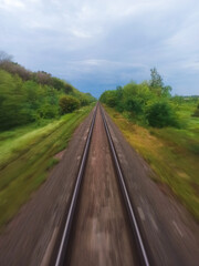 Obraz premium View from the train window on the rails going into the distance