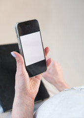 white screen of mobile phone in female hands