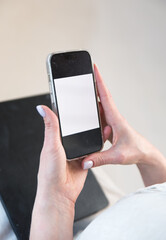 white screen of mobile phone in female hands