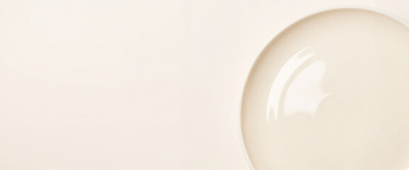 Glossy ceramic plate close-up on neutral pastel background, modern elegance