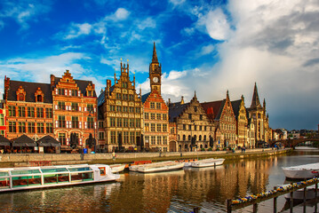Ghent city historical center, tourists boats and colorful buildings on Leie river bank, Belgium