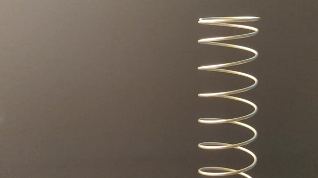 Metal spiral close-up shots on a black background with empty space for advertising