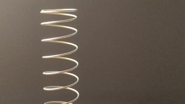 Metal spiral close-up shots on a black background with empty space for advertising