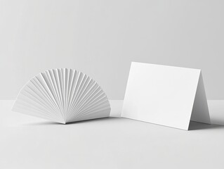 Blank white folded card and fan mockup on white background.
