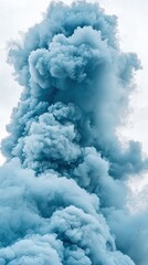 Blue smoke plume rising against a cloudy sky, ideal for backgrounds or abstract art