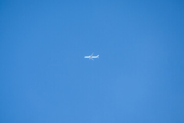 a twin engined jet liner aircraft in deep blue sky