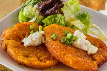 crispy fried green tomato topped with goat cheese and green onion