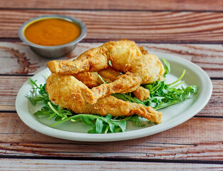 crispy fried frog legs with a spicy remoulade dipping sauce