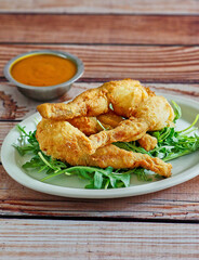 crispy fried frog legs with a spicy remoulade dipping sauce