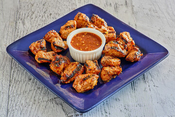 grilled gator bites served with a orange dipping sauce