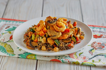 pan roasted scallops and shrimp on a bed of wild rice with mixed vegetables
