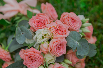 A beautiful wedding bouquet of fresh flowers lies on the green grass wedding day. beautiful pink flowers. close-up