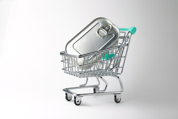 Shopping cart carrying a can on white background