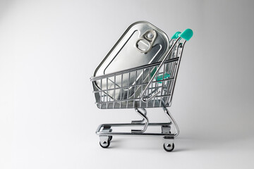Shopping cart carrying a single can on white background