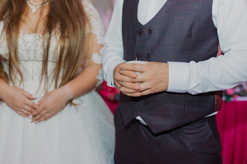 Naklejka premium The newlyweds at the wedding holds a candle in their hand to light the family hearth