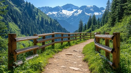 Stunning view of a sunlit mountain valley with lush green meadows and dense evergreen forests. Rugged snow-capped peaks rise above with a wooden fence in the foreground. 