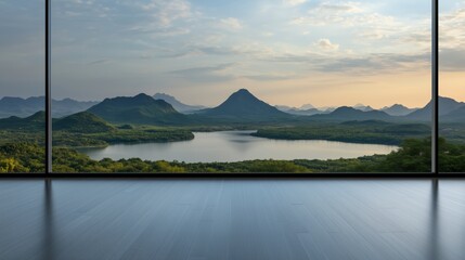 Scenic mountain view from a modern glass-walled room overlooking a tranquil lake at sunset