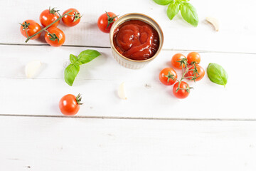 Tomato paste, sauce, ketchup and cherry tomatoes on branches and basil