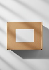 Cardboard box mockup with blank label casting shadow on white background