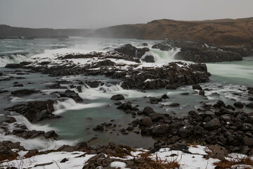 Urridafoss waterfall in Iceland on a foggy winter day